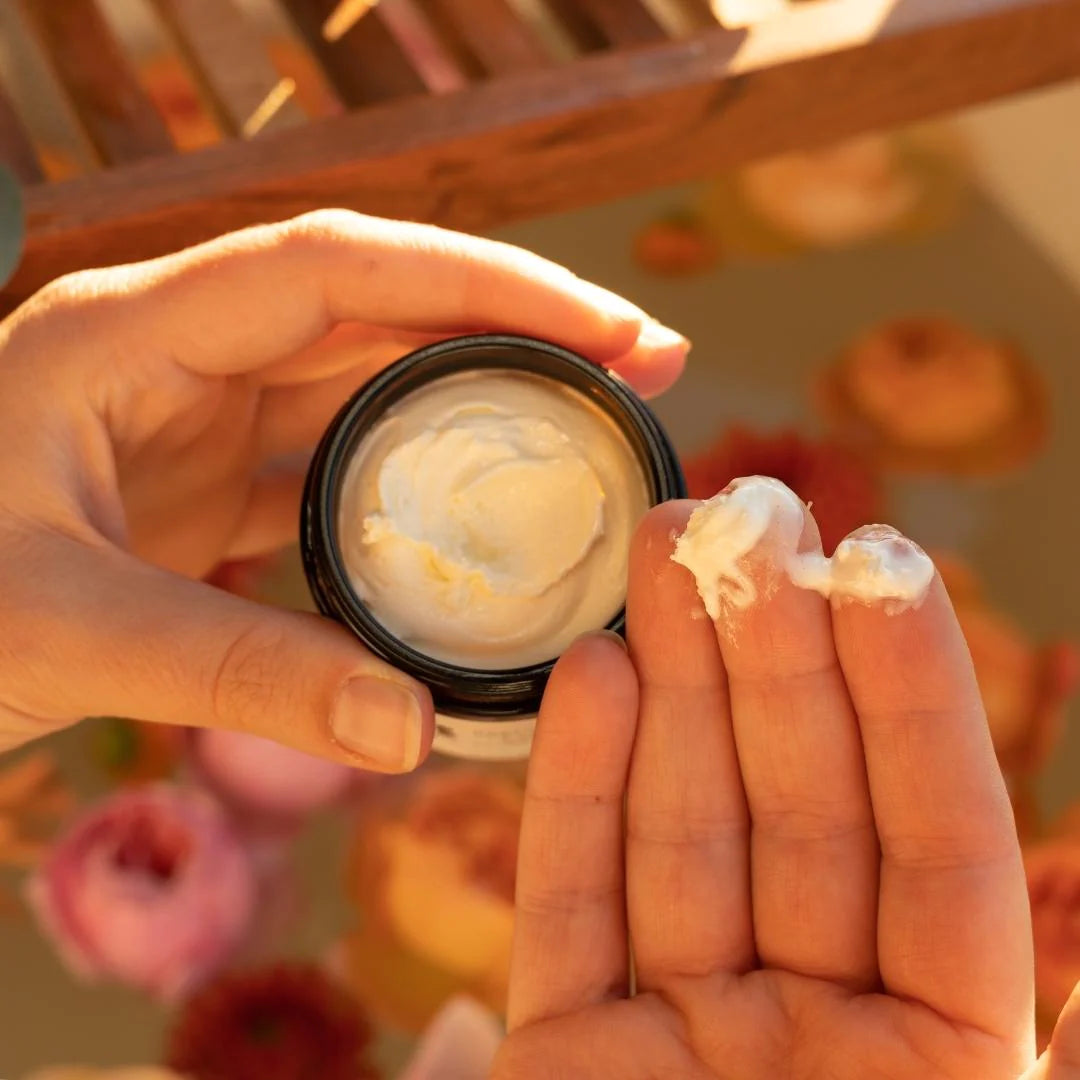 A person applying 8 Days Botanicals Organic Body Butter Joy to their hands.