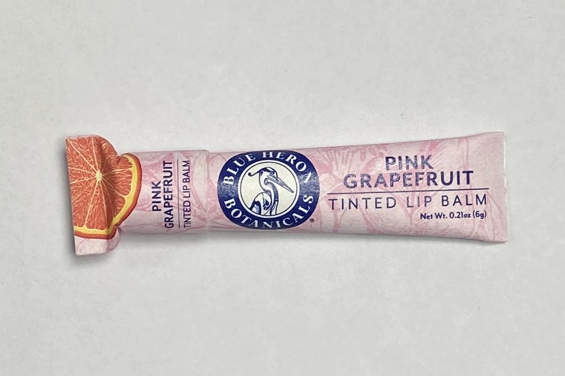 A tube of Tinted Grapefruit Blue Heron Botanicals Lip Balm.