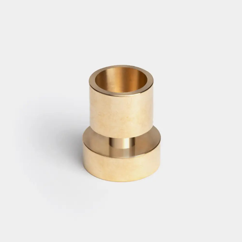A Brass Taper Candle Holder against a white background.